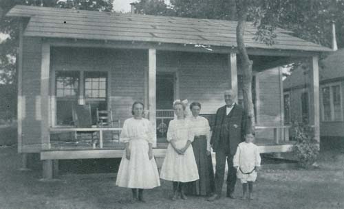 Kelsey family in front of their cabin